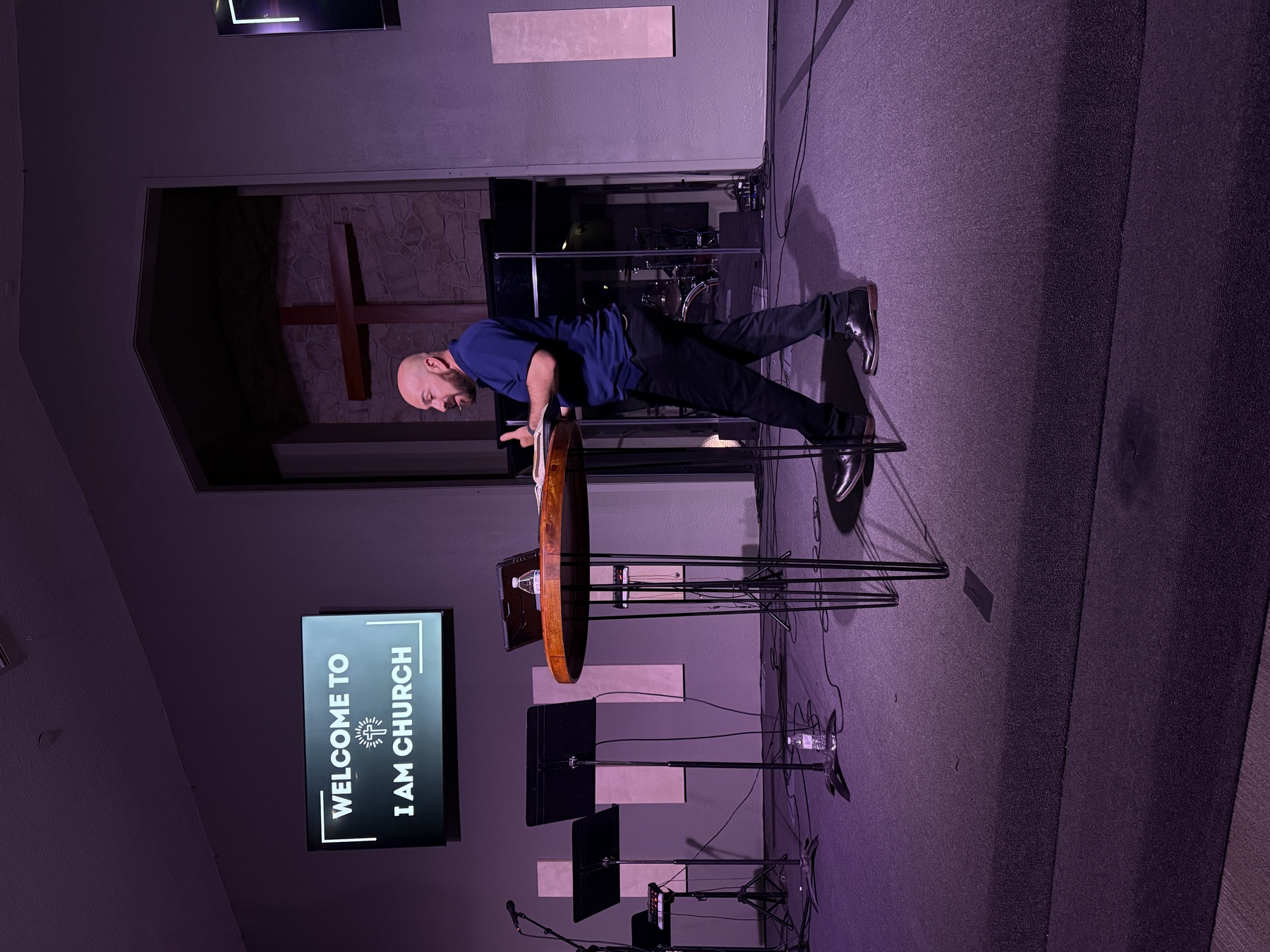 Pastor teaching on the platform at I AM Church